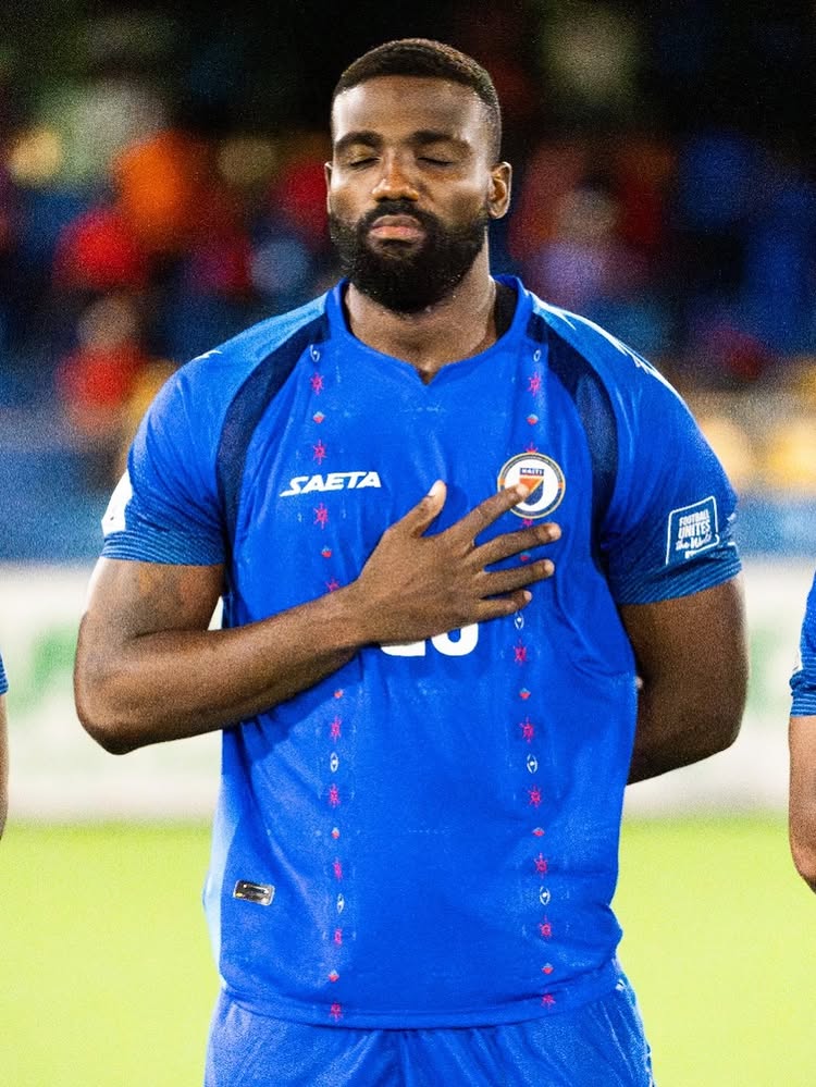 Haiti player with hand on heart during national anthem